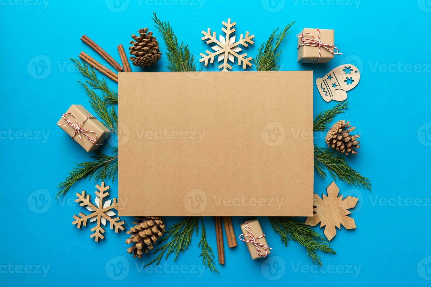 Flat lay Christmas composition. square Paper blank, pine tree branches, christmas decorations on Colored background. Top view, copy space for text photo