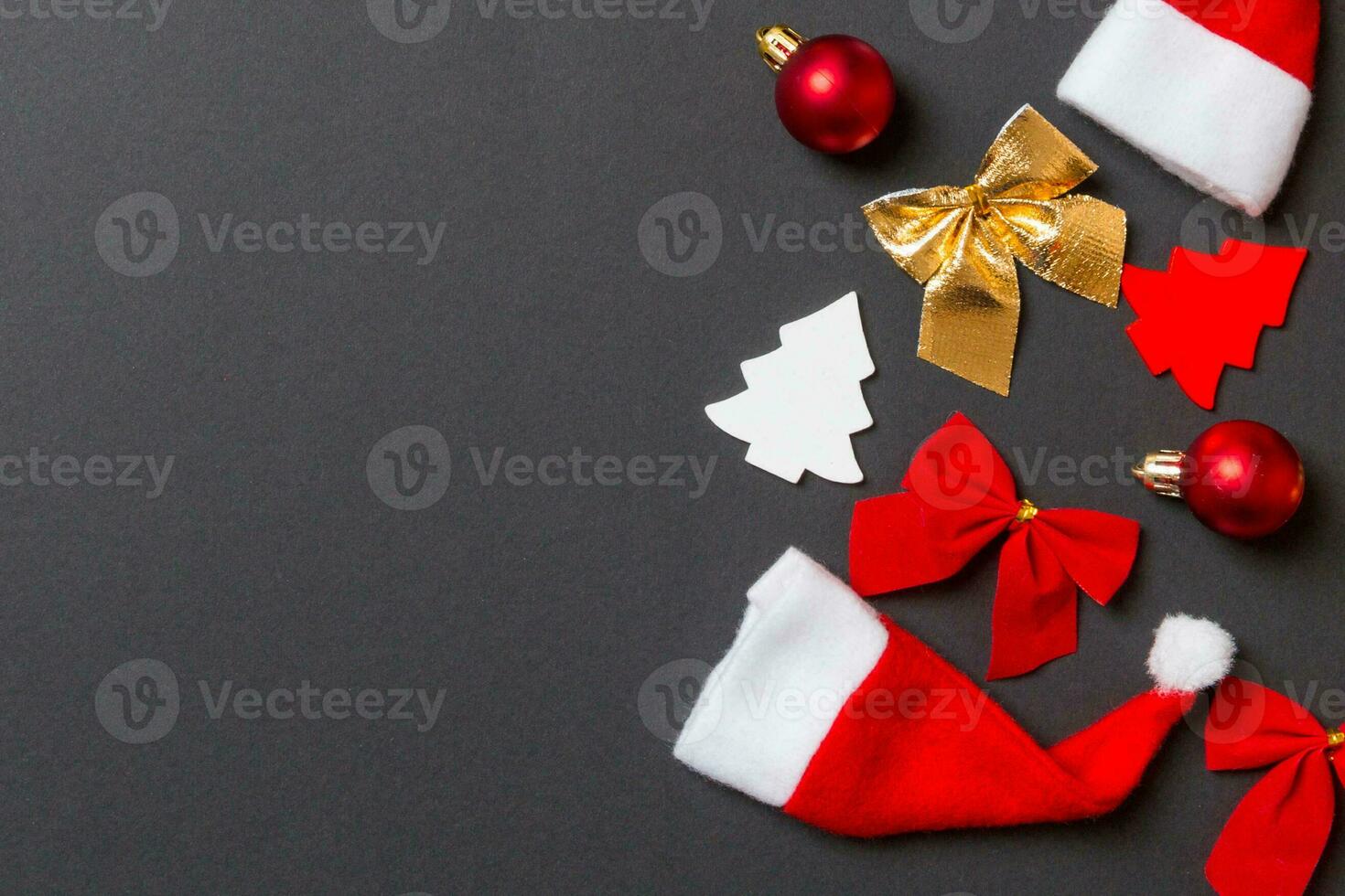 Top view of black background with New Year toys and decorations. Christmas time concept with copy space photo