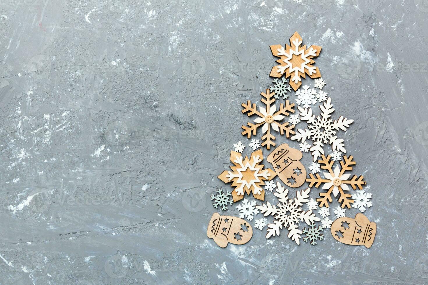 Christmas tree made from colored handmade ball decoration on colored background, view from above. New Year minimal concept with copy space photo