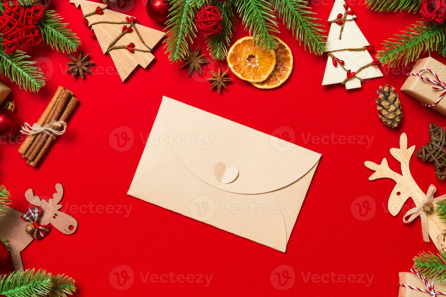 Top view of envelope on red background. New Year decorations. Christmas holiday concept photo