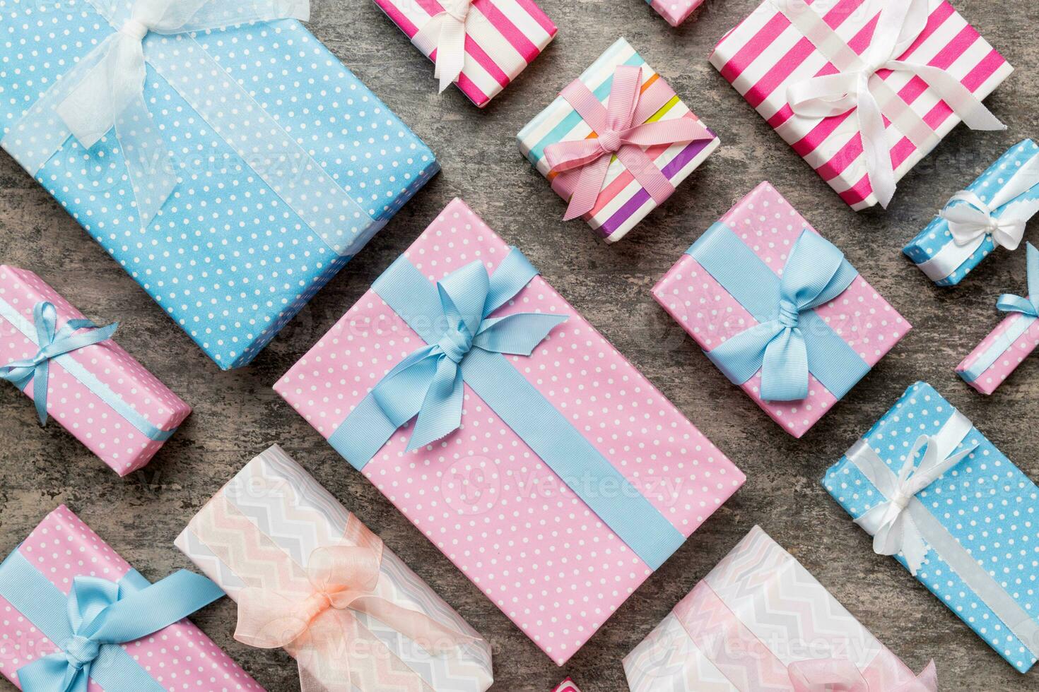 A lot of Christmas gift boxes in colored paper decorated on table, Top view close up. Many present New Year gift photo