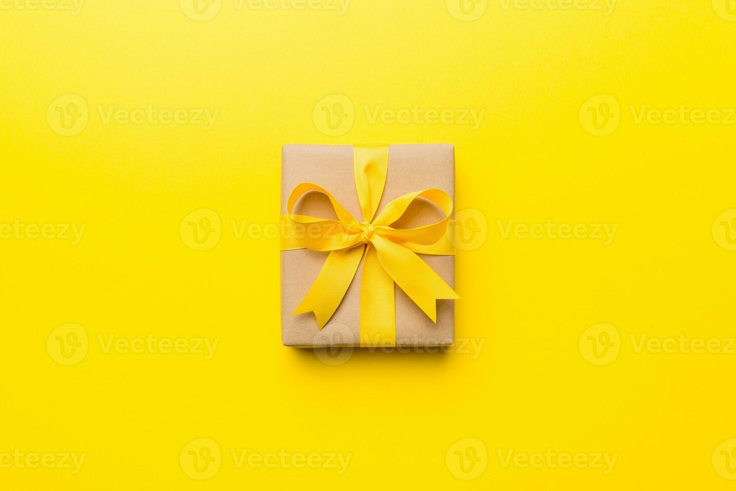 Holiday present box over colored background, top view. Copy space for design photo