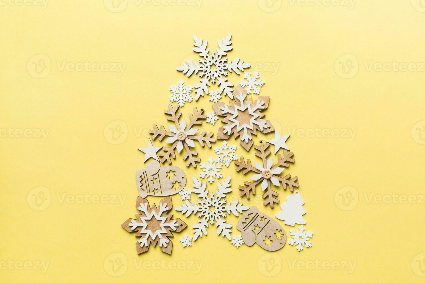 Christmas tree made from colored handmade ball decoration on colored background, view from above. New Year minimal concept with copy space photo