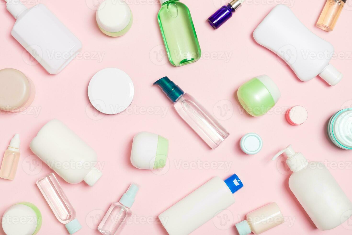 Group of plastic bodycare bottle Flat lay composition with cosmetic products on pink background empty space for you design. Set of White Cosmetic containers, top view with copy space photo