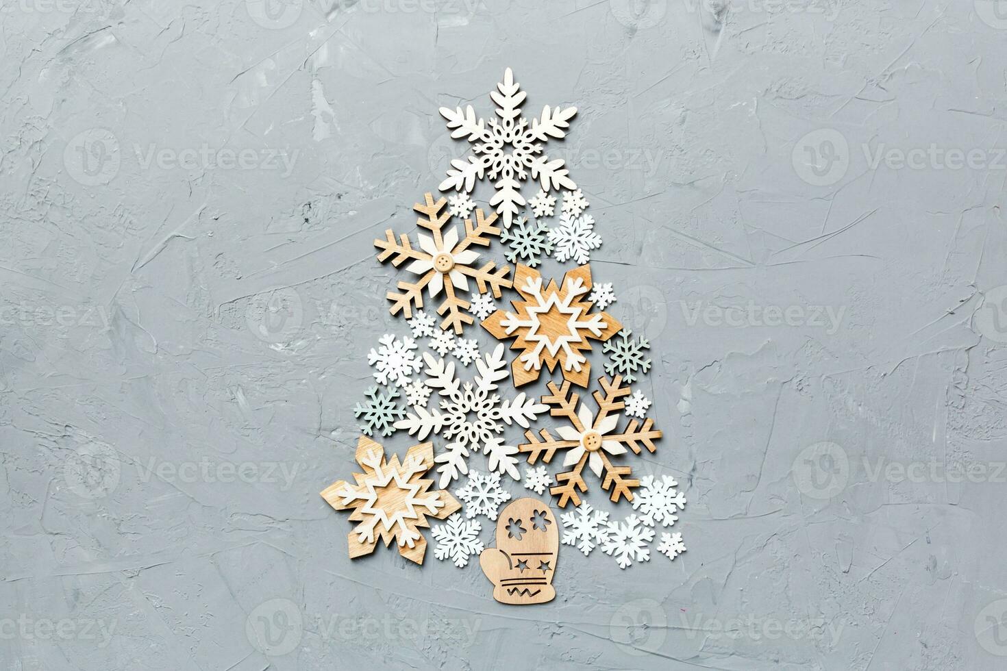 Christmas tree made from colored handmade ball decoration on colored background, view from above. New Year minimal concept with copy space photo