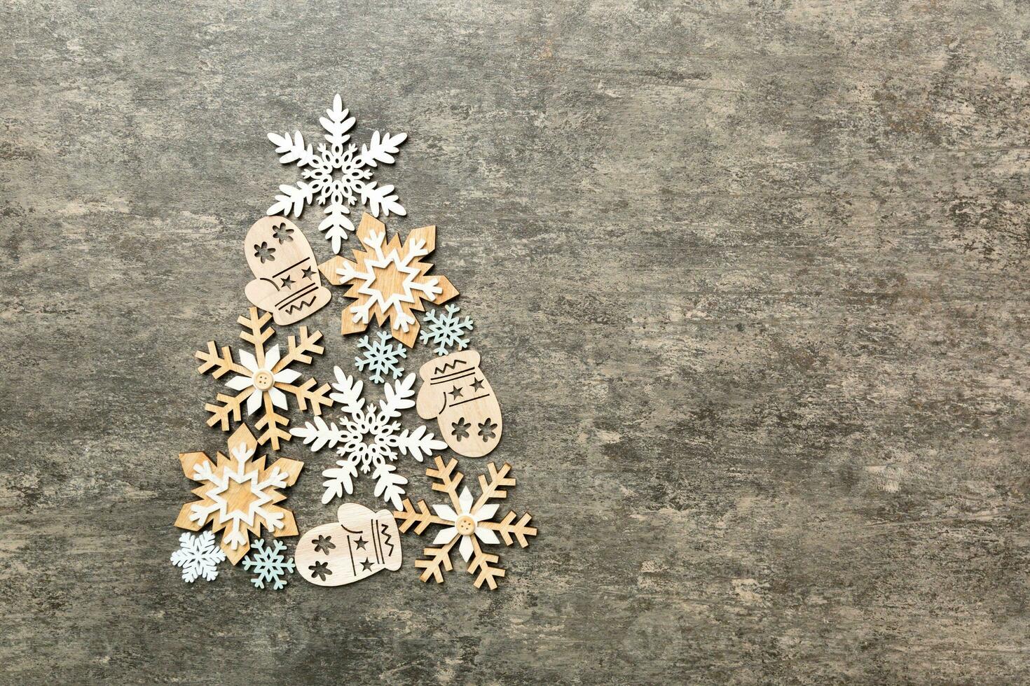 Christmas tree made from colored snowflakes decoration on colored background, view from above. New Year minimal concept with copy space photo