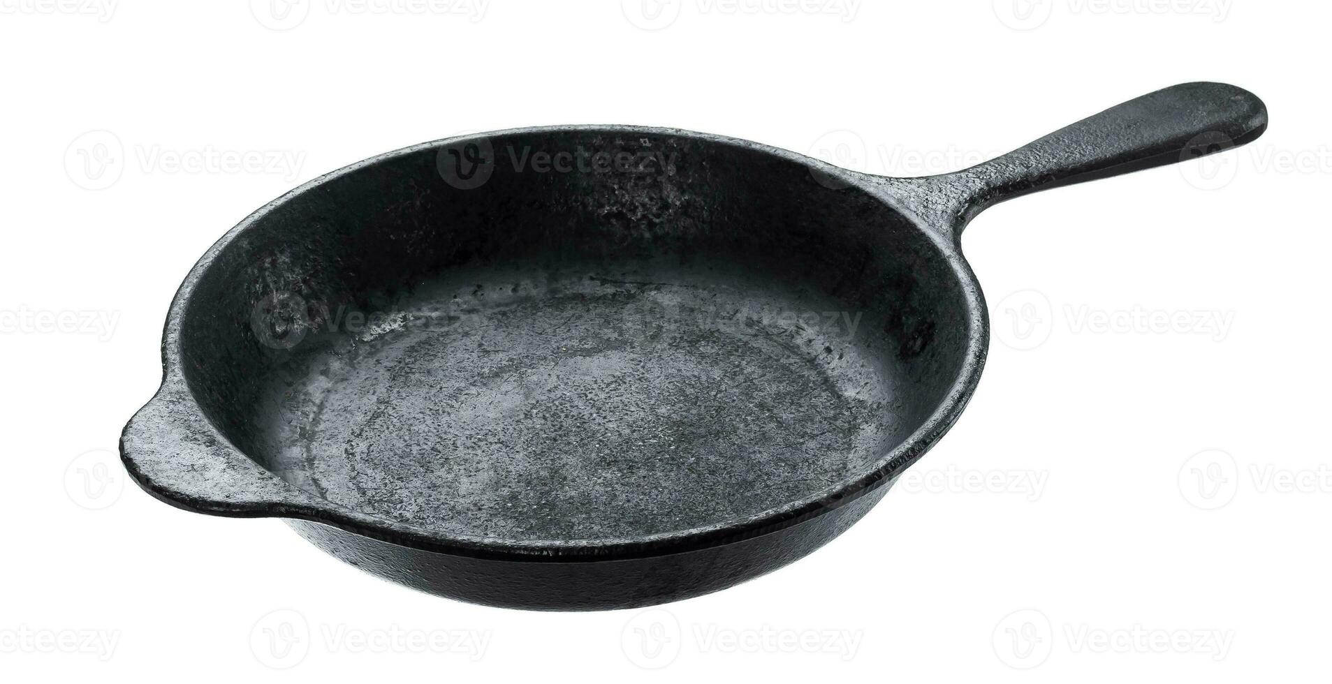 Old cast iron pan isolated on white background photo