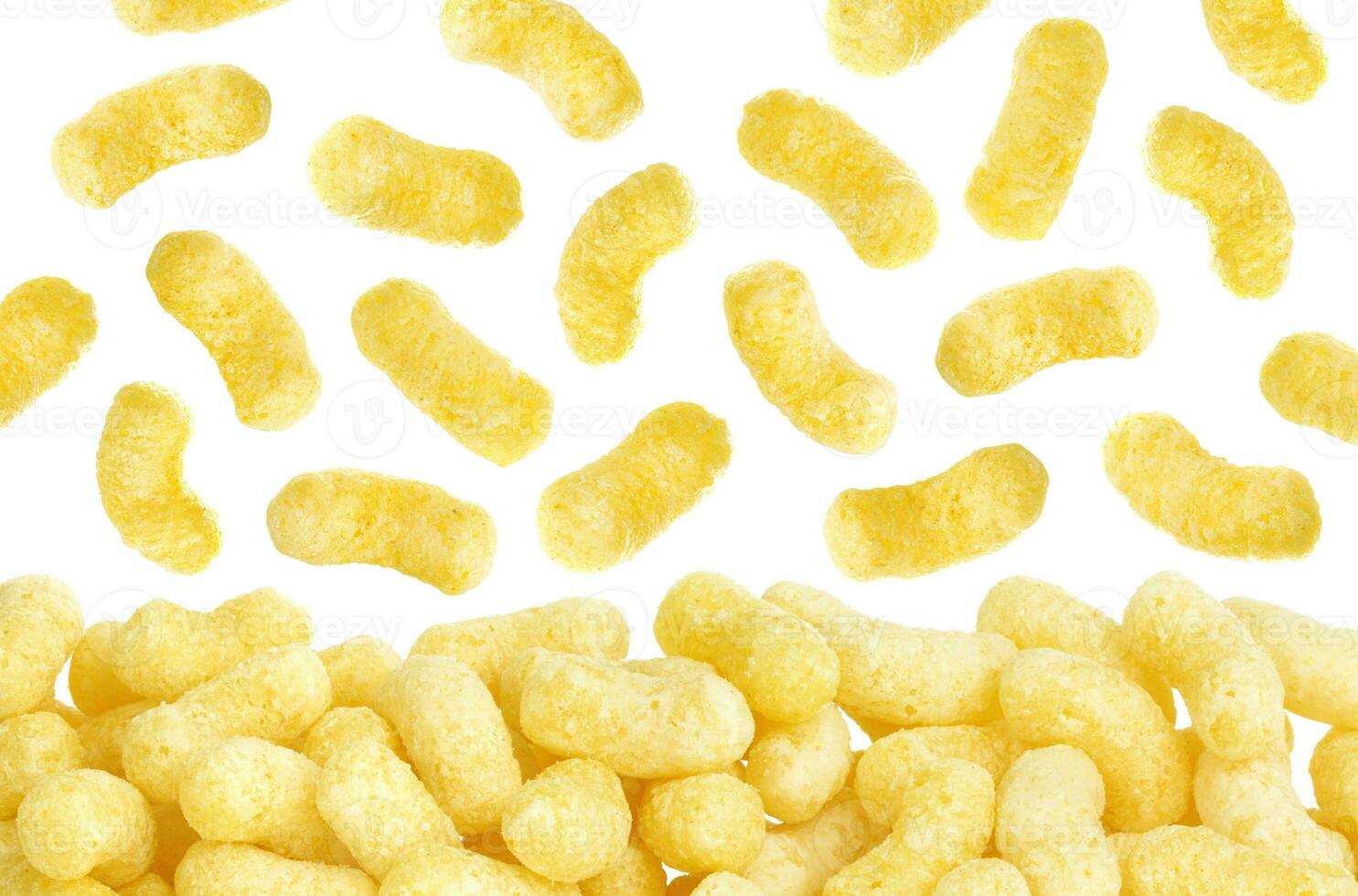 Crunchy corn sticks flakes isolated on white background photo
