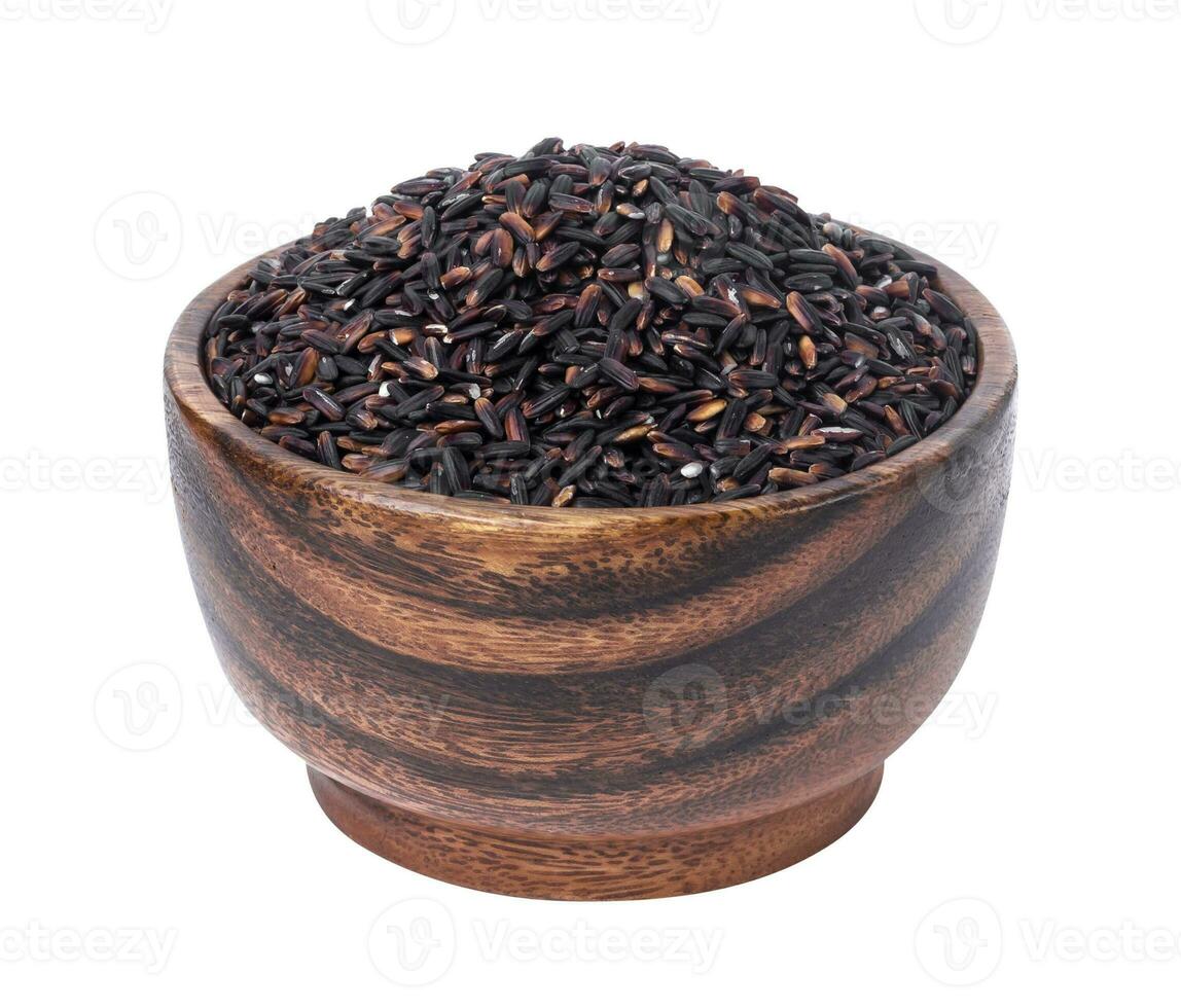 Black rice in wooden bowl isolated on white background photo