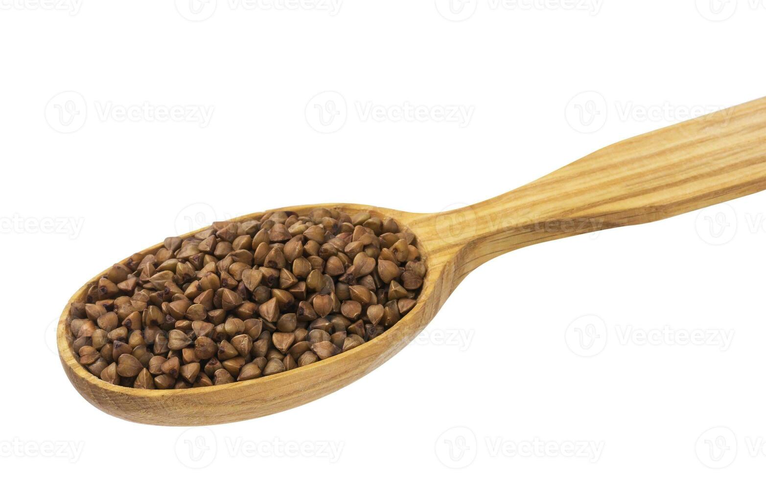 Buckwheat in wooden spoon isolated on white photo