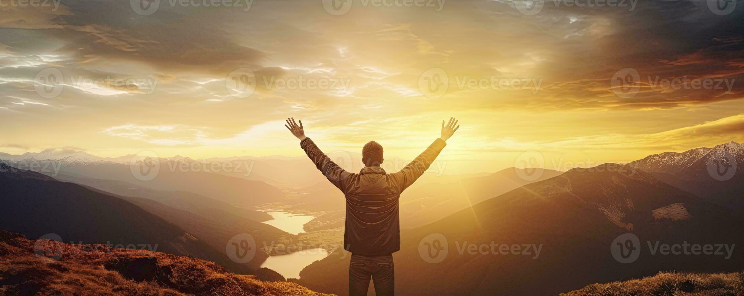 Positive man celebrating with arms raised up at Mountain landscape at sunset, Generative AI photo
