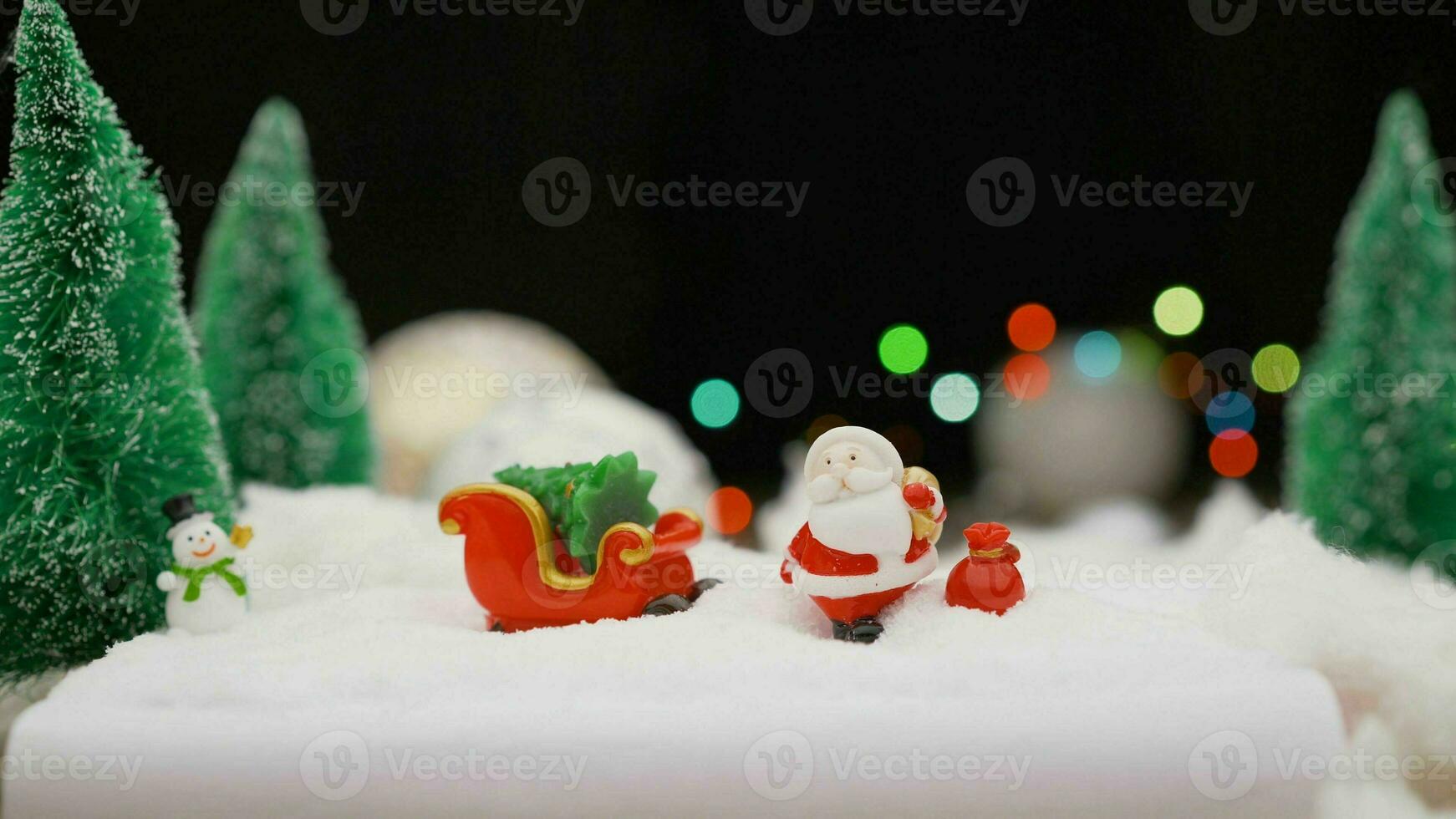 Christmas toy on garland background. Toy Santa Claus on the background of light bulbs. Christmas background Santa Claus with a gift. photo