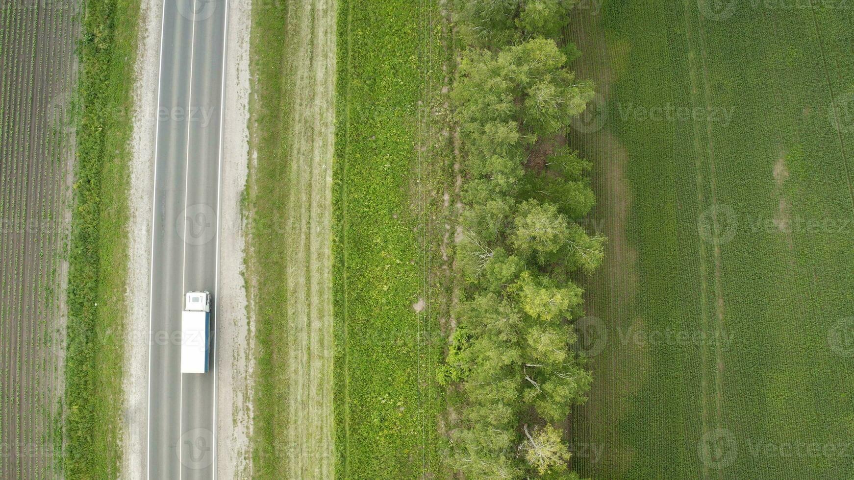 top view, aerial photos and road cars moving along the highway. Road and field top view.