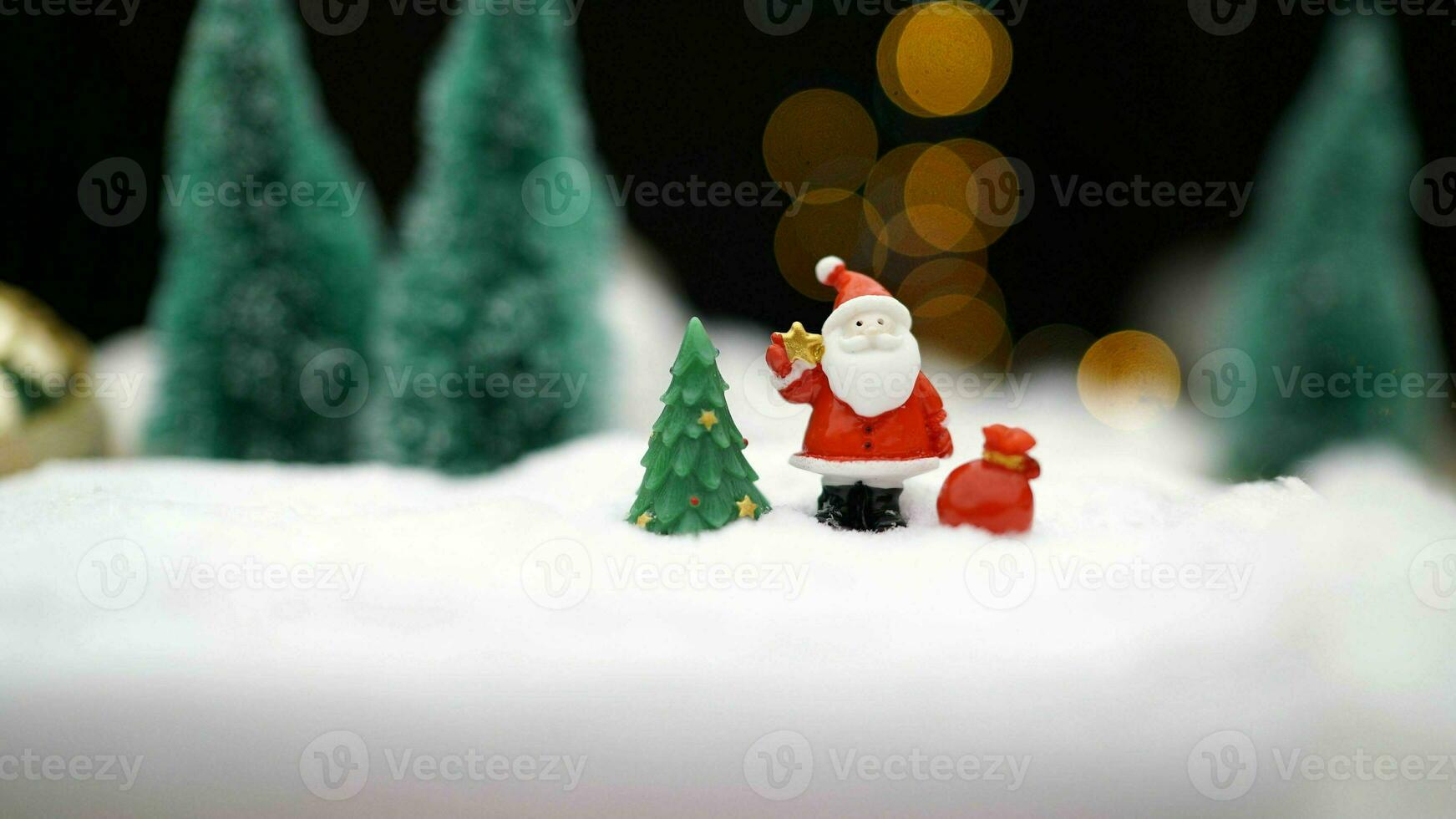 Christmas toy on garland background. Toy Santa Claus on the background of light bulbs. Christmas background Santa Claus with a gift. photo