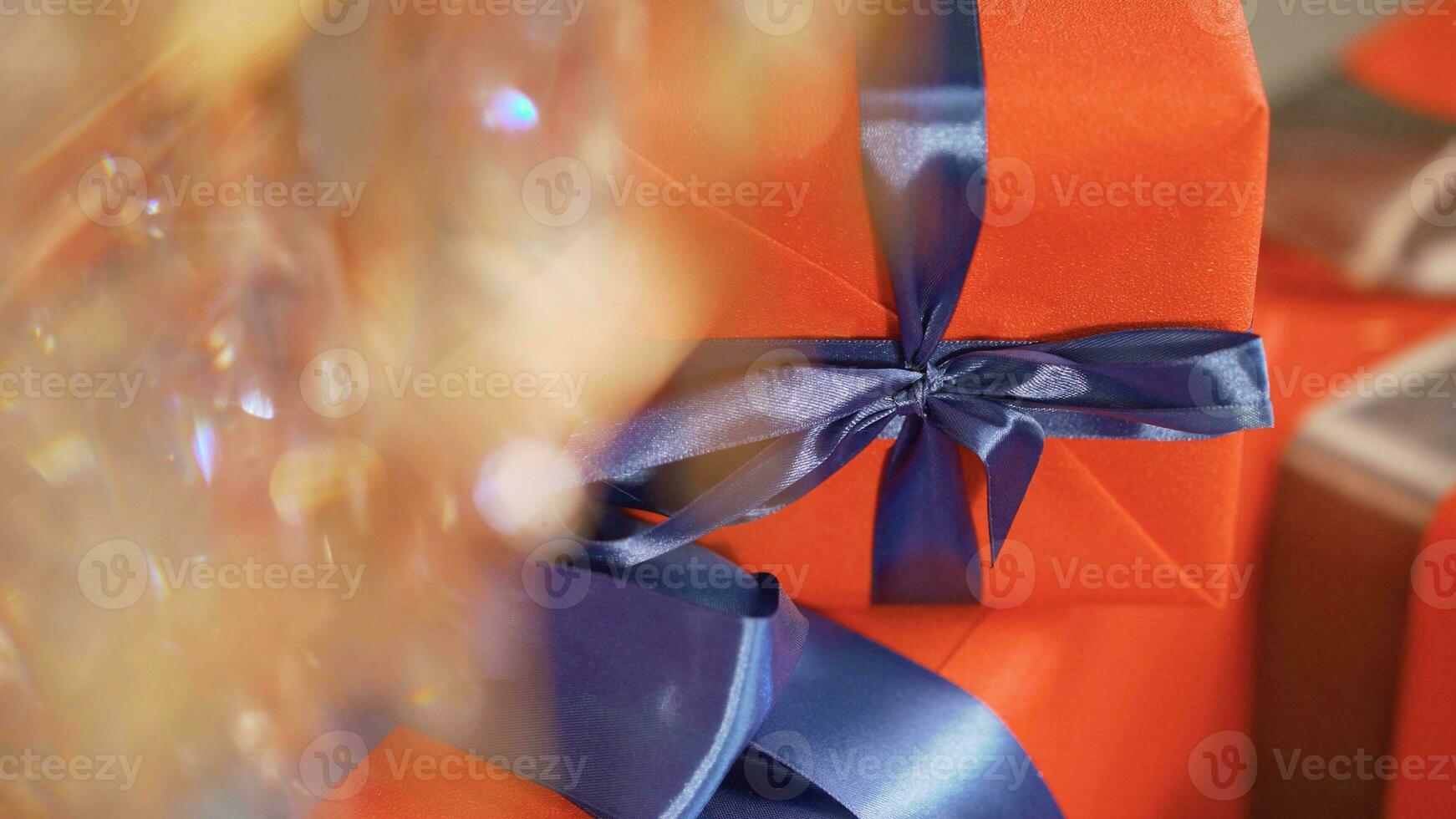 New Year's gifts in bright packaging. Gifts on the background of a Christmas tree with a bokeh. photo