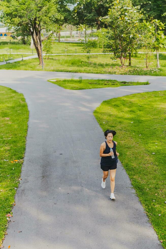 Woman running in the park at morning. photo