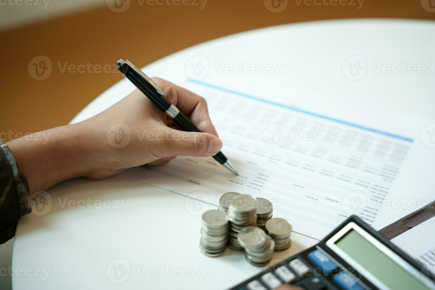 Saving money. Businessman Accountant verify growing business and saving money stacking coins with calculator. Accountancy Concept photo