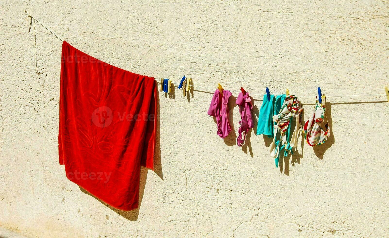 a red towel hanging on a clothesline photo