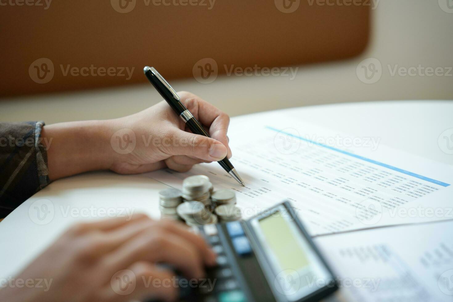 Saving money. Businessman Accountant verify growing business and saving money stacking coins with calculator. Accountancy Concept photo