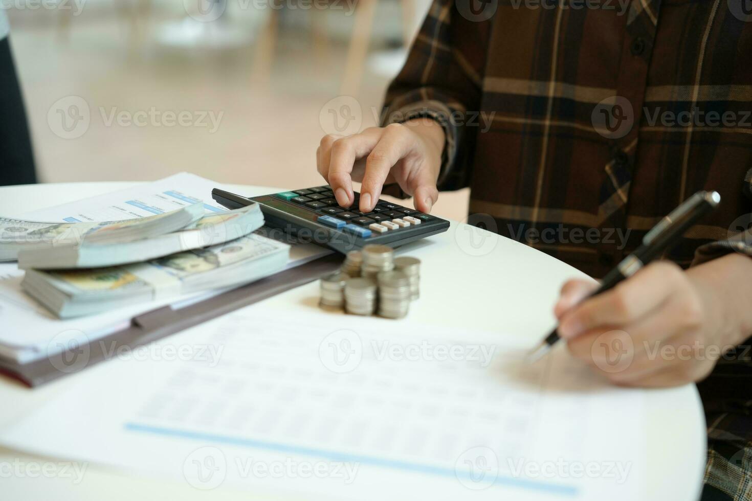 Saving money. Businessman Accountant verify growing business and saving money stacking coins with calculator. Accountancy Concept photo