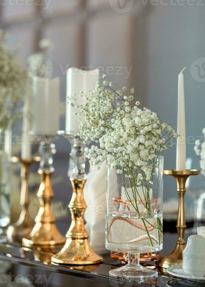 Gold candle holder on a mirror glass luxury decor at modern wedding. photo