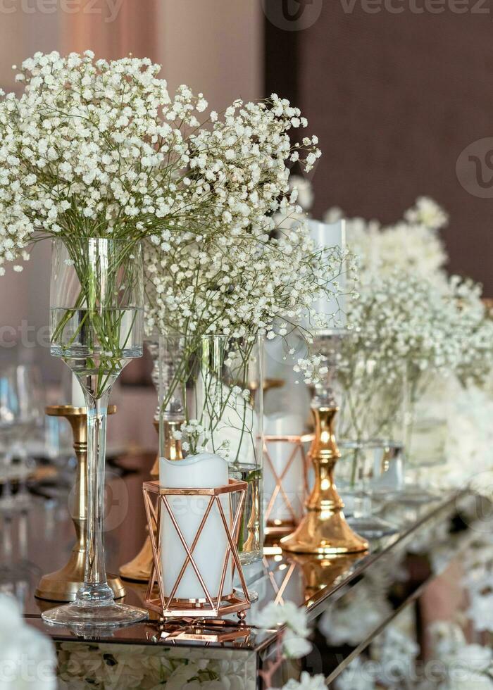 Gold candle on luxury table at modern wedding. Softfocus lateral view photo