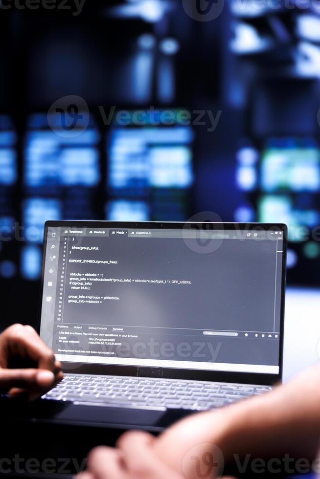 Admin team maintaining and updating server rigs, writing lines of code on laptop terminal, close up. Coders using JavaScript, Java, and database programming to ensure seamless data center computing photo
