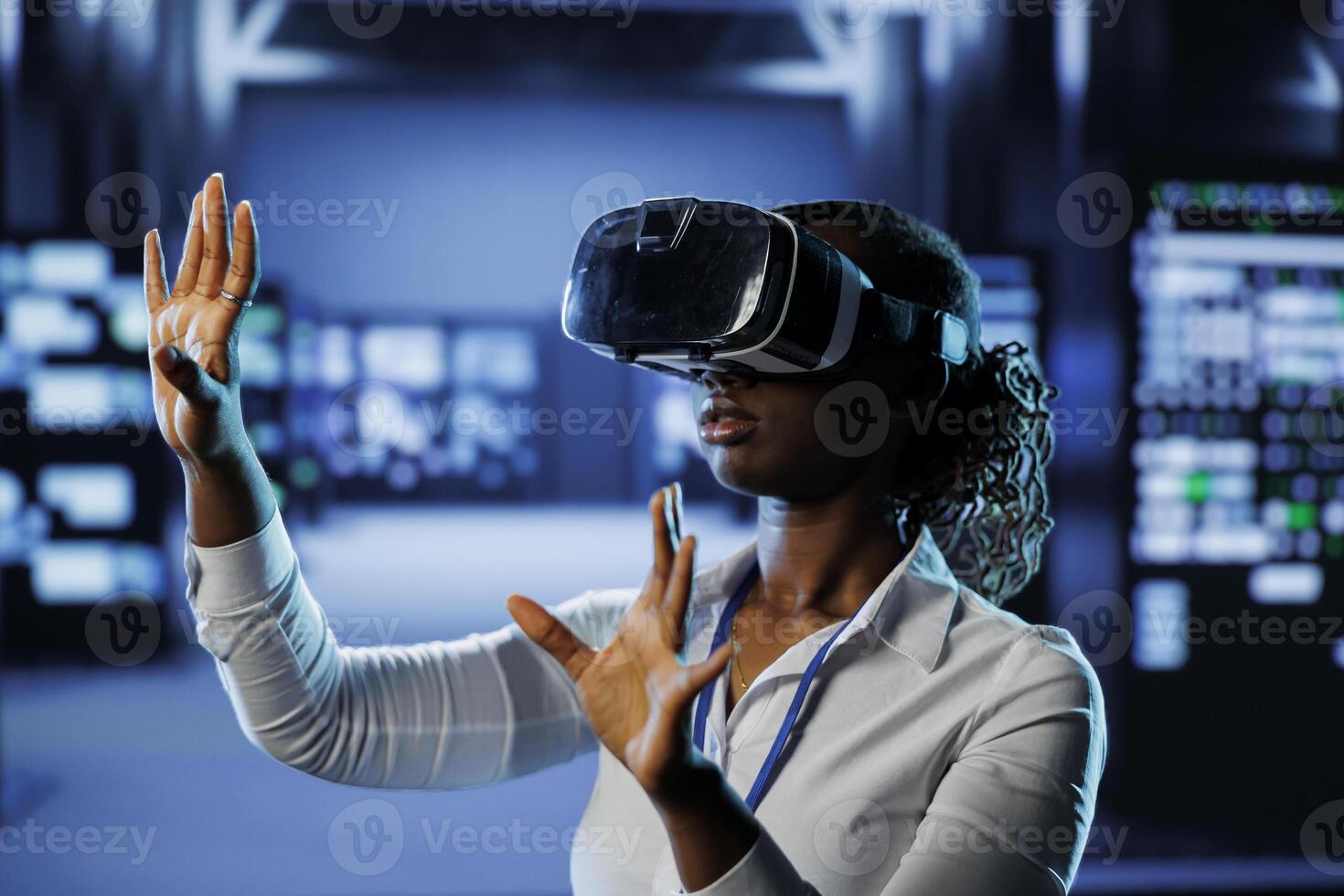 Trained technician in data center uses virtual reality to prevent system overload. Experienced VR headset user in server room ensuring enough network bandwidth for smooth operations photo