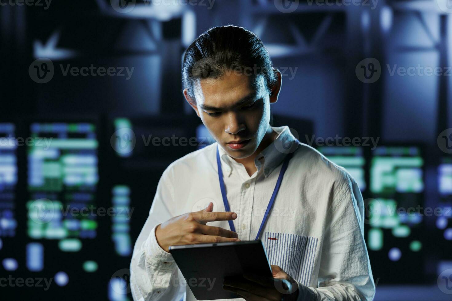 Tech support worker between server hub clusters providing processing resources for businesses worldwide. Overseeing supervisor fixes data center mainframes used for managing massive databases photo