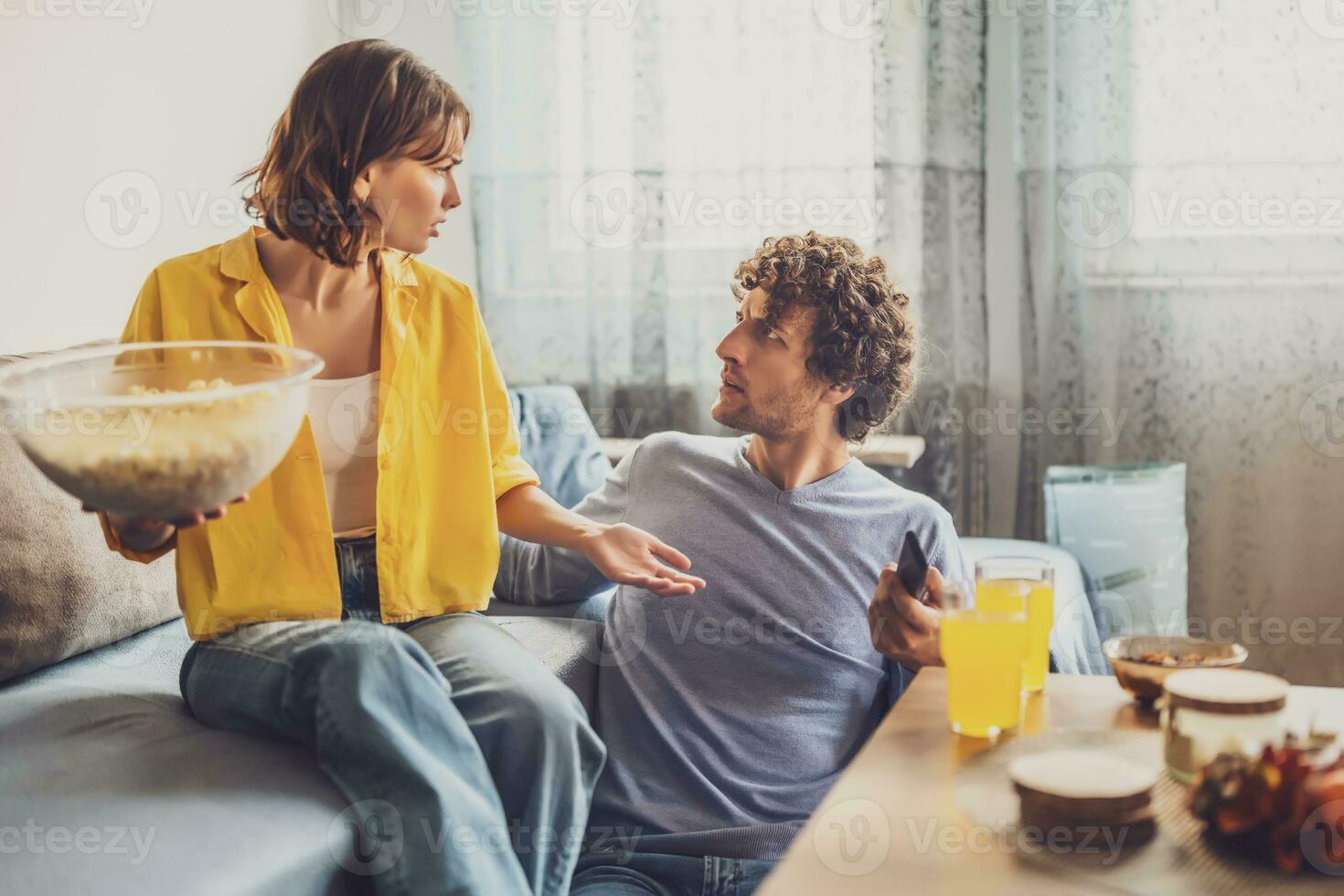 Man and woman are sitting at sofa and arguing. Relationship problems. photo