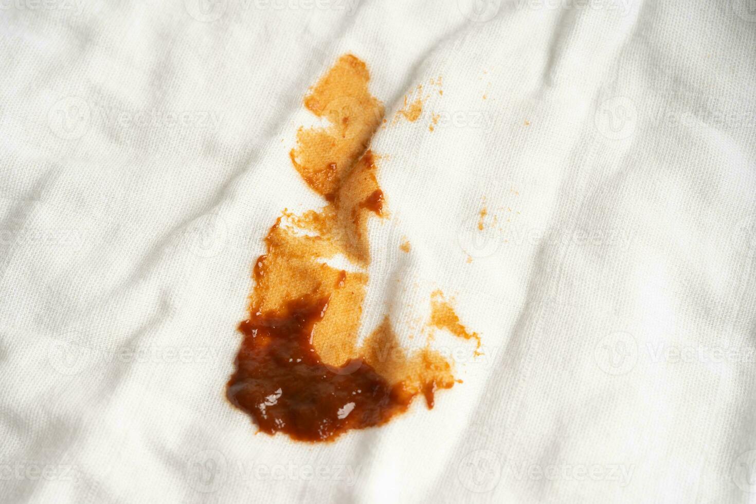 Dirty sauce stain on cloth to wash with washing powder, cleaning housework concept. photo