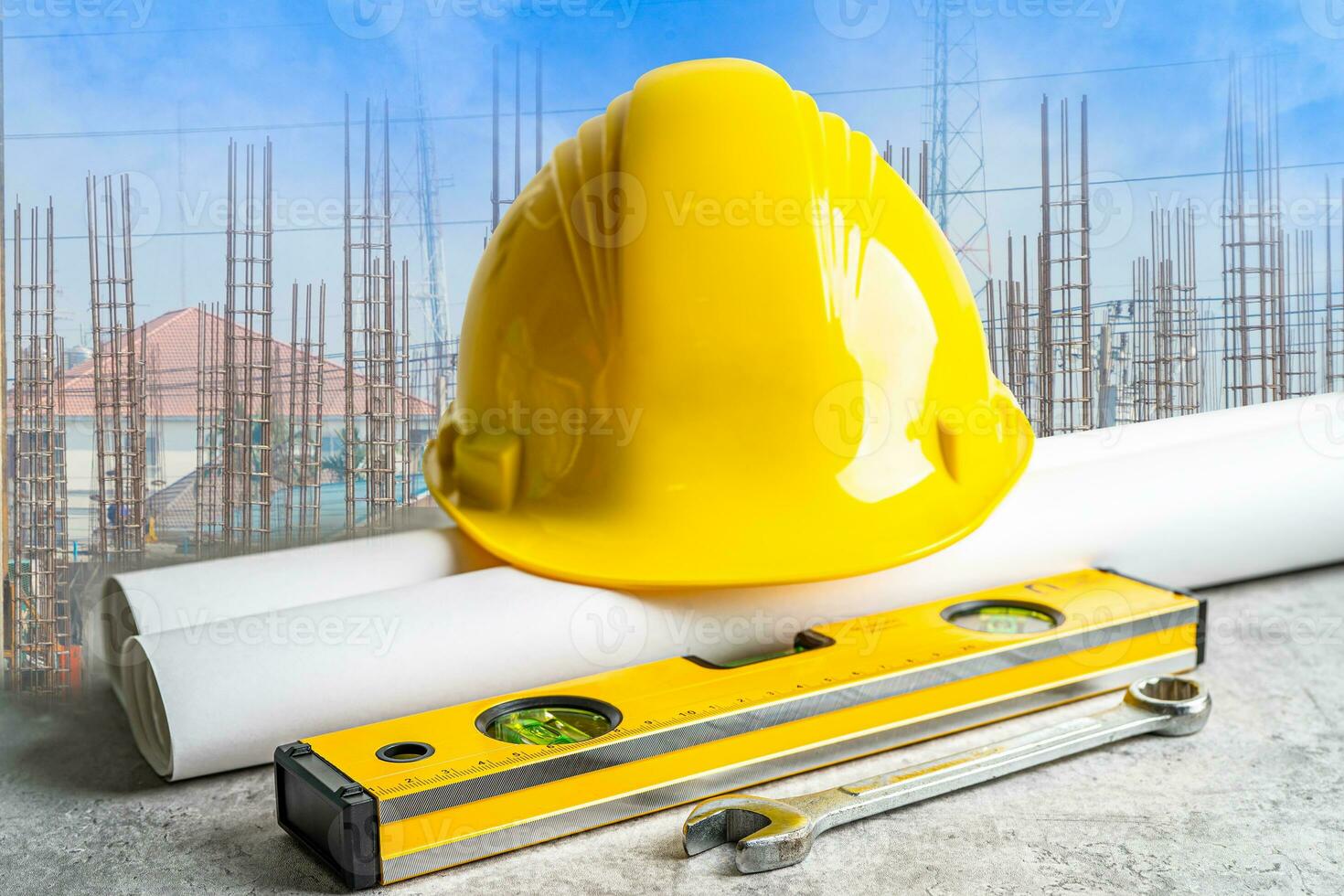 Safety first hard helmet hat and engineer tool at construction estate site background. photo