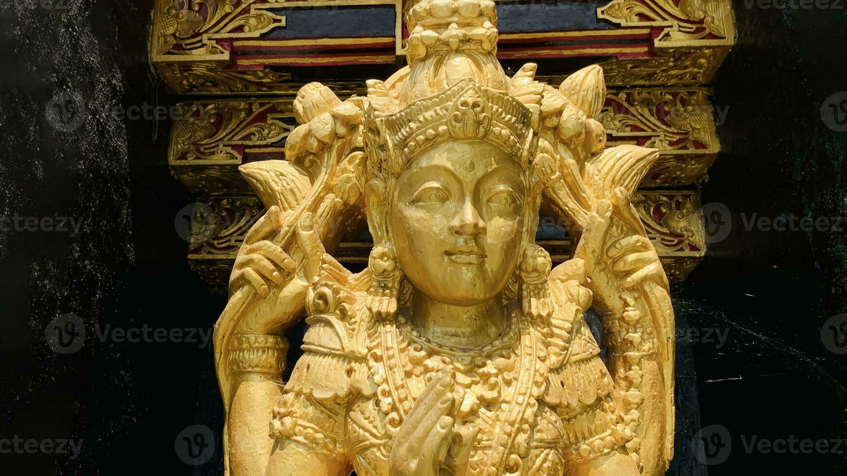 Balinese Hindu God golden Shiva Durga statue on a sacred Hindu temple in Indonesia photo