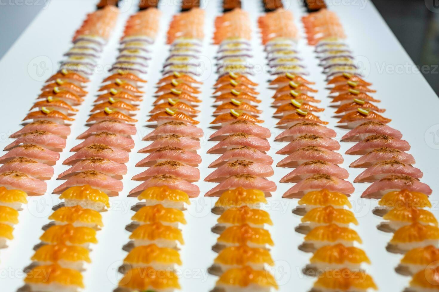 a long row of sushi on a table photo