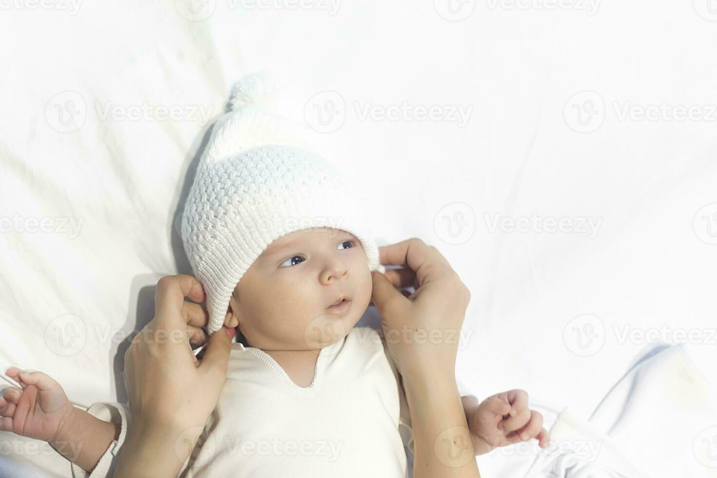 newborn baby in the arms of his mother photo