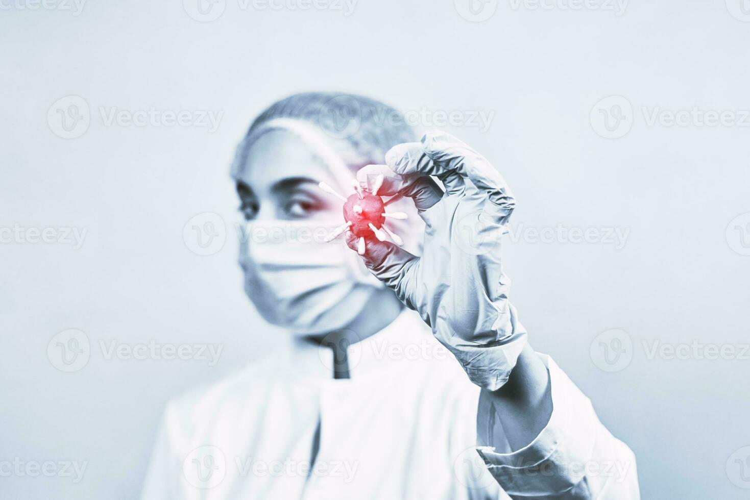 Female doctor in protective medical uniform holding coronavirus photo