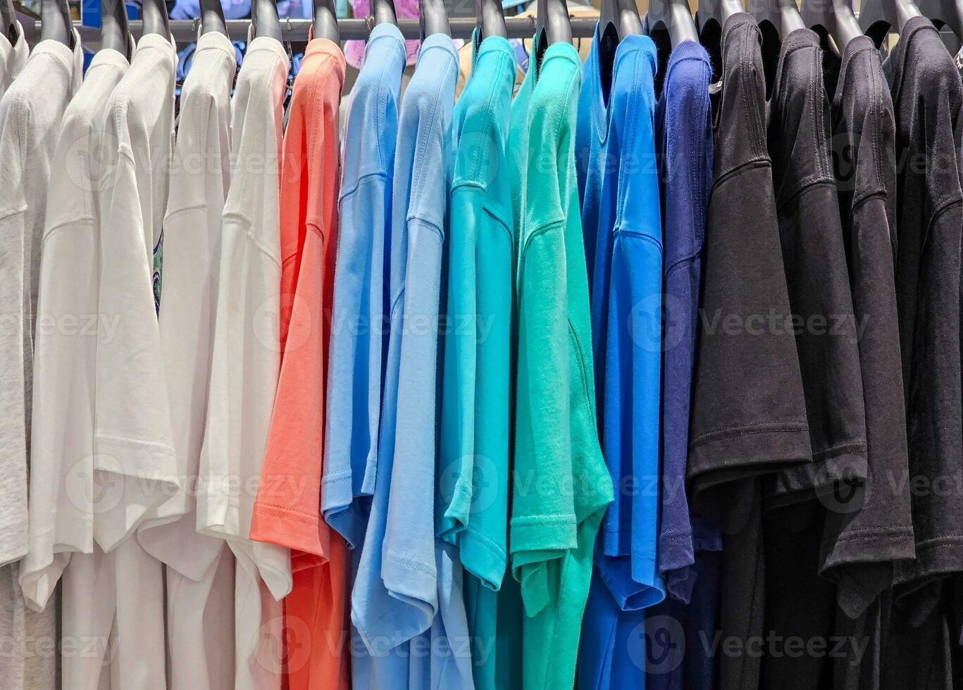 Colorful T-shirts on Hanger in Store. photo