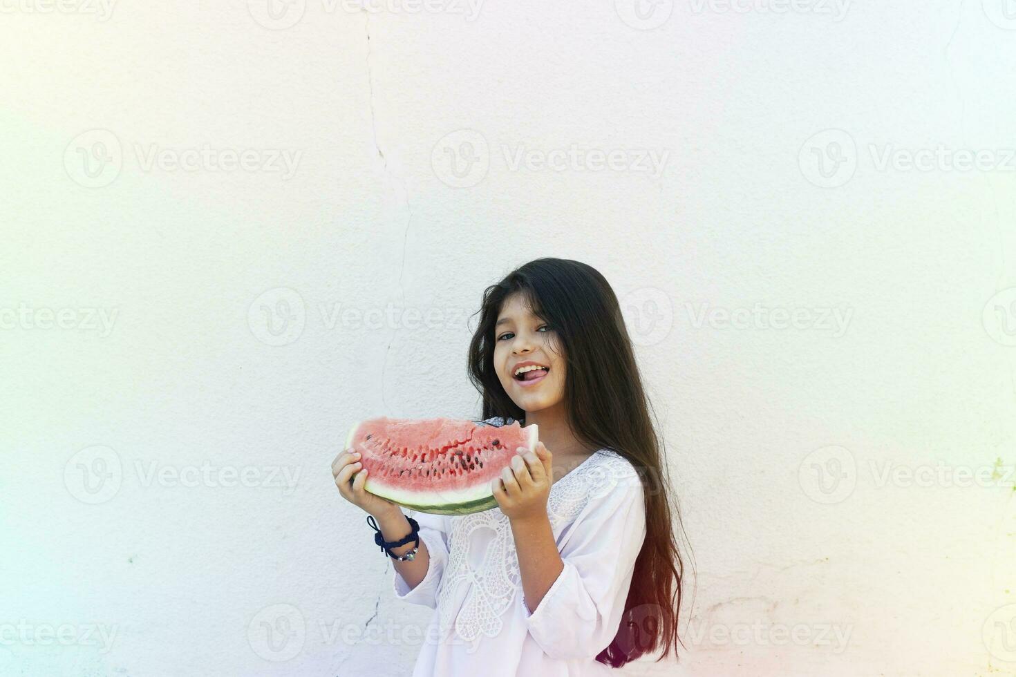 Pre-teen girl eating watermelon. Happy childhood. Summer girl. photo