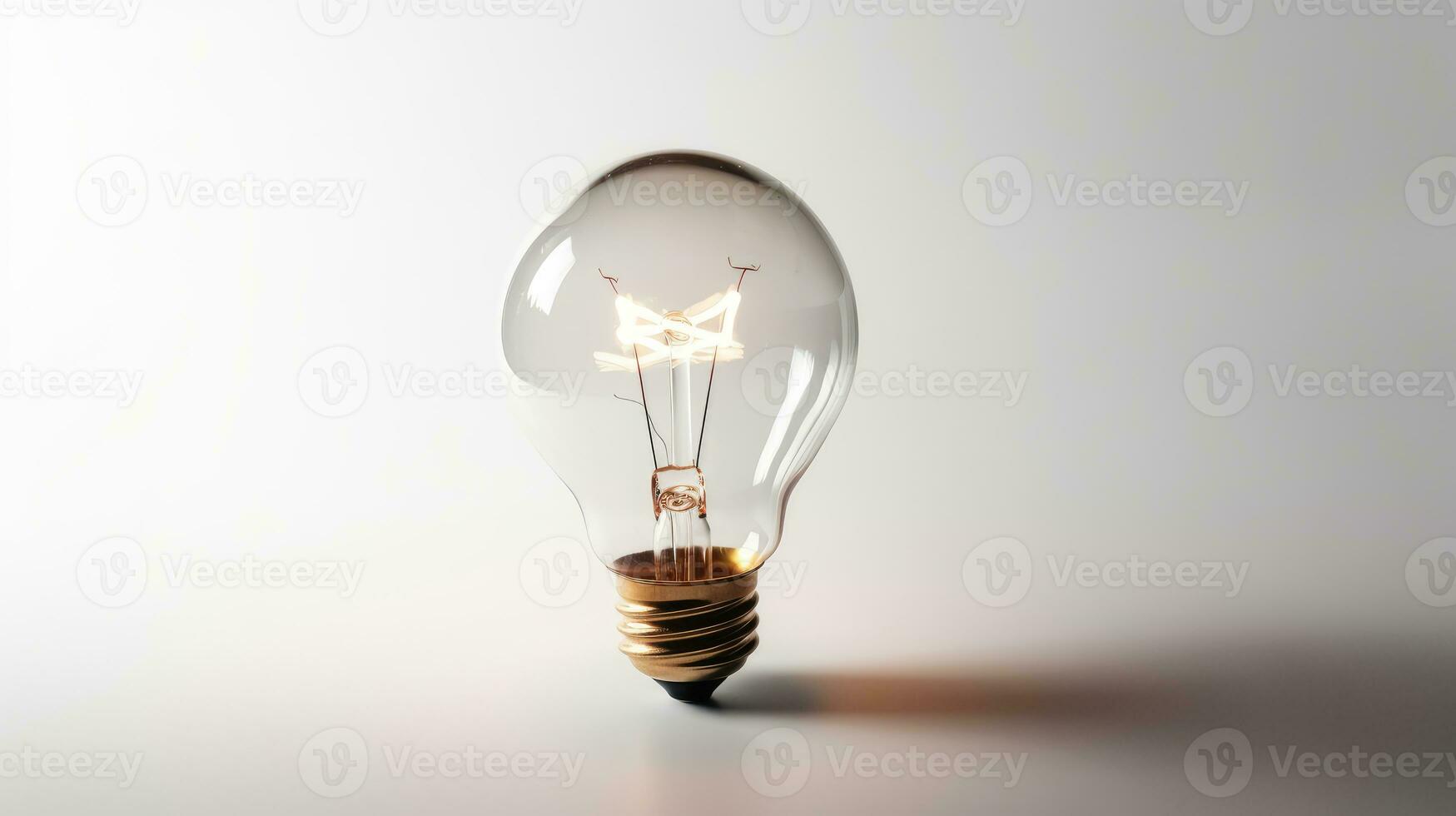 Glowing glass light bulb on grey background photo