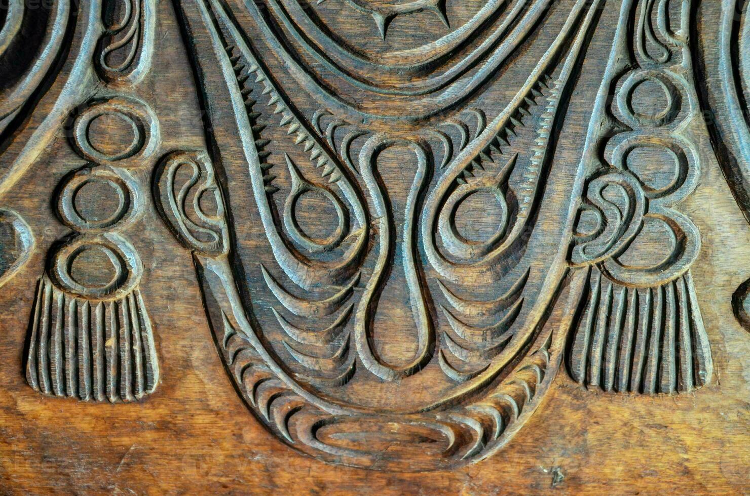 carved wood panel with intricate designs photo