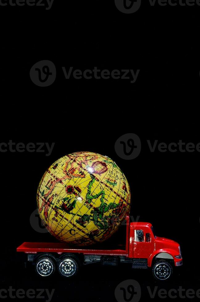 a toy truck with a large globe on top photo