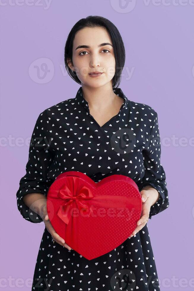 Portrait of young middle-eastern woman with gift box. Romantic giftbox photo
