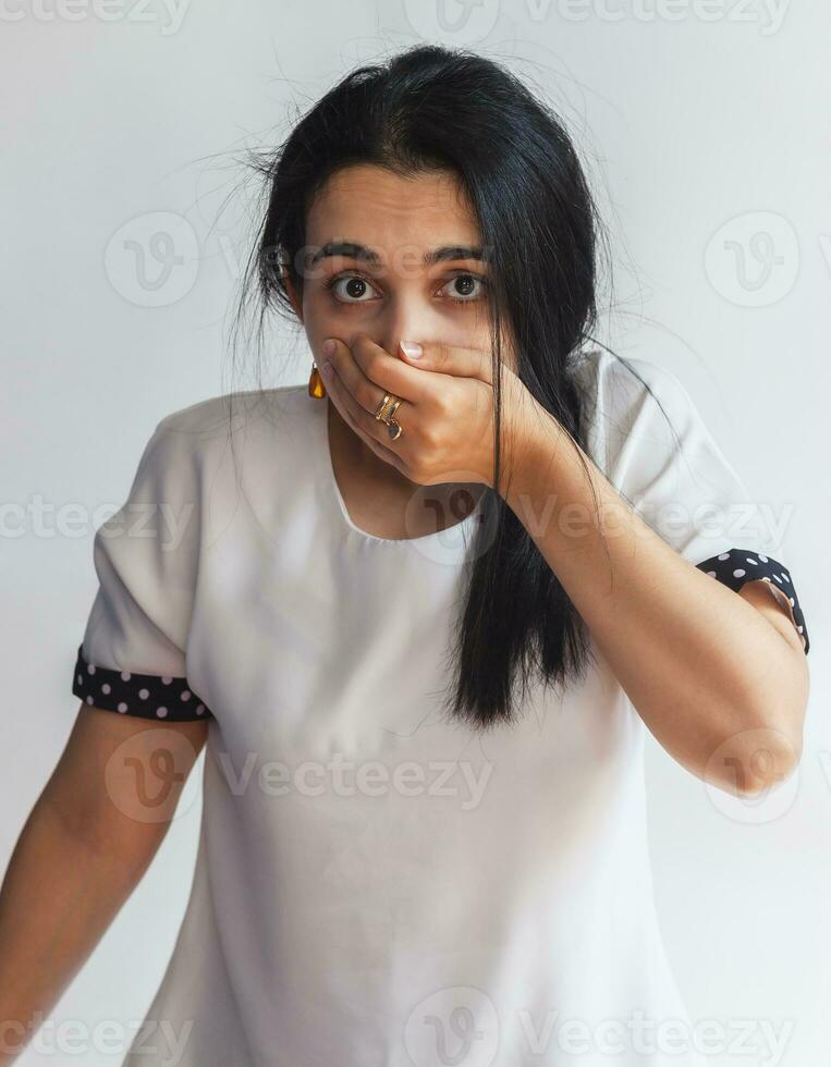 Oops. Portrait of silly woman with hand on mouth for mistake, remember error, thinking oops, after making a stupid mistake or remembering, feeling dumb. Forgot, bad memory concept. Facial expression photo