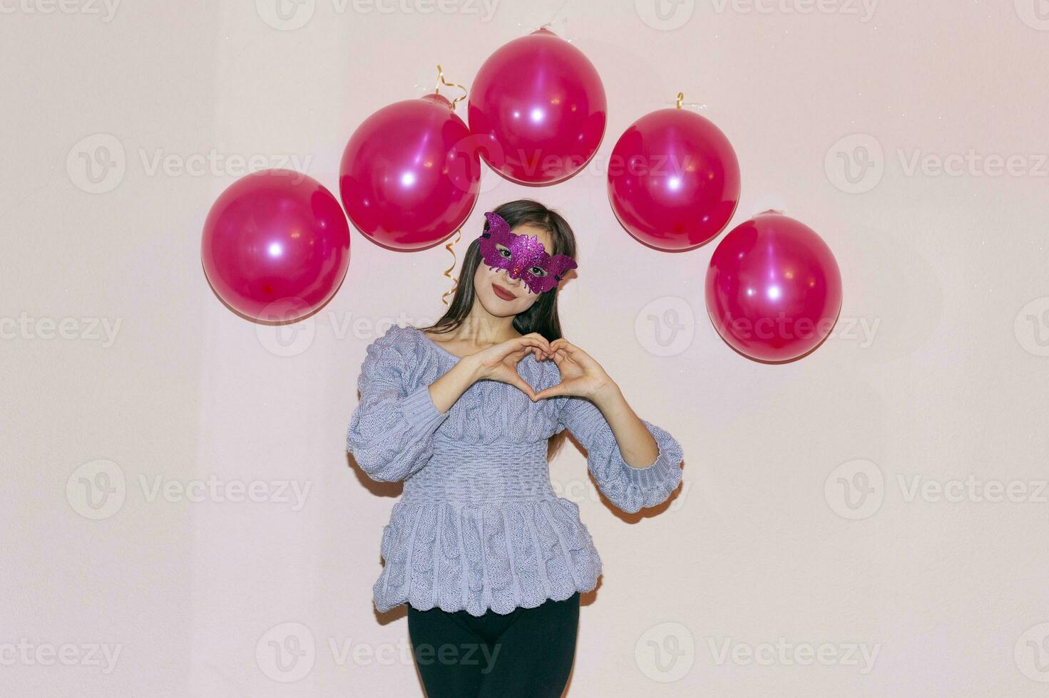 Cute mixed race girl in masquerade mask. Valentines day, birthday, womens day, anniversary, holiday celebration concept photo