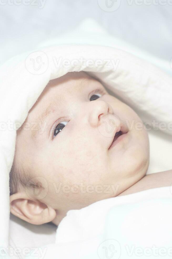 Adorable cute newborn baby boy on white background. The lovely child wore a rabbit costume with long ears. Holiday, Easter. photo