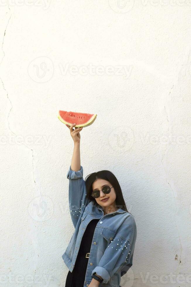 Beautiful young girl eating watermelon. Summer girl. photo