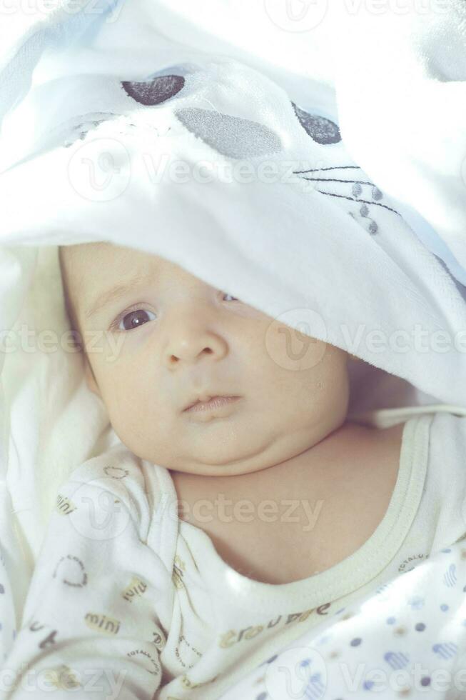 Adorable cute newborn baby boy on white background. The lovely child wore a rabbit costume with long ears. Holiday, Easter. photo