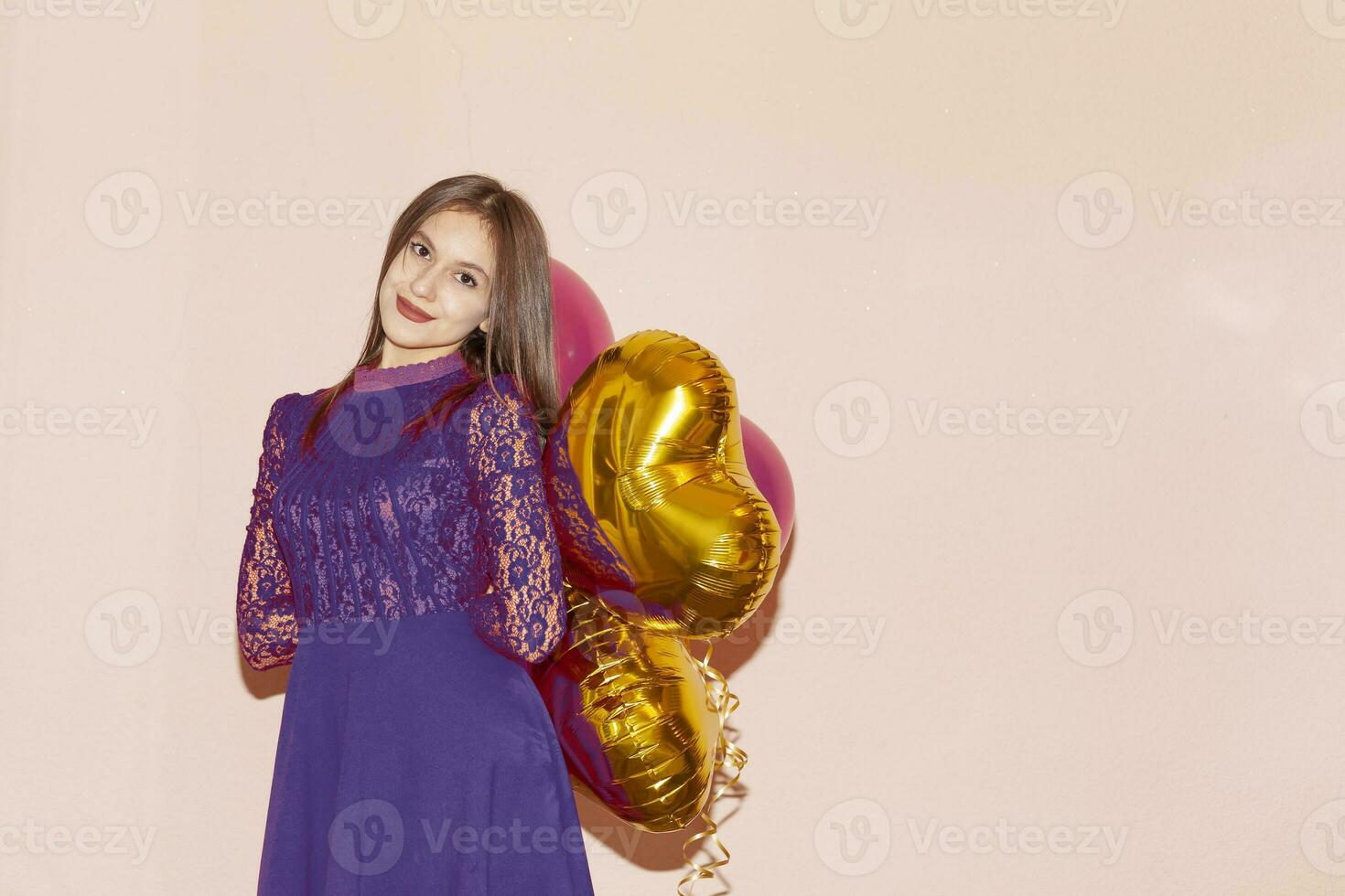 woman holds heart shaped golden air balloons. valentines day, birthday, womens day, anniversary, holiday celebration concept photo