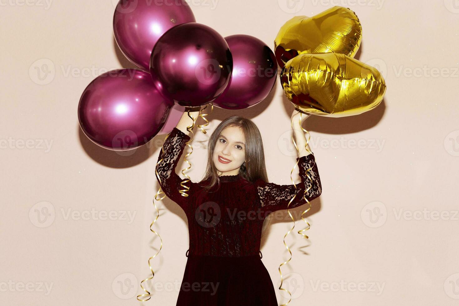 woman holds heart shaped golden air balloons. valentines day, birthday, womens day, anniversary, holiday celebration concept photo