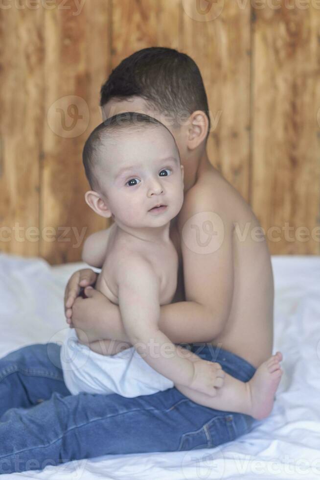 Happy childhood concept. Happy brothers portrait. 6 years and 6 months old boys having fun. Two little kids smiling having good time. Cute little brothers lying and playing together photo